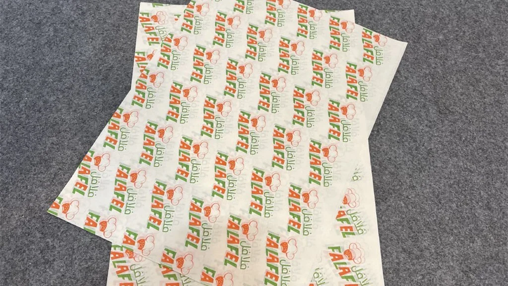 Pre-printed thermal receipt paper roll showing clear brand logo